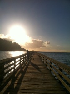 sun breaking thru on pier